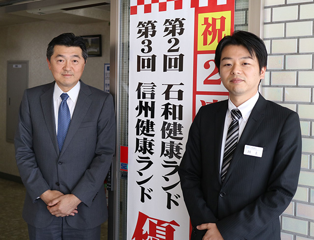 クア・アンド・ホテルの三森中社長(左)と川上淳一本社管理本部長